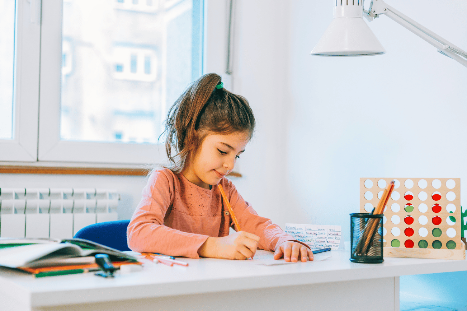 Child working at a desk doing 11+ revision